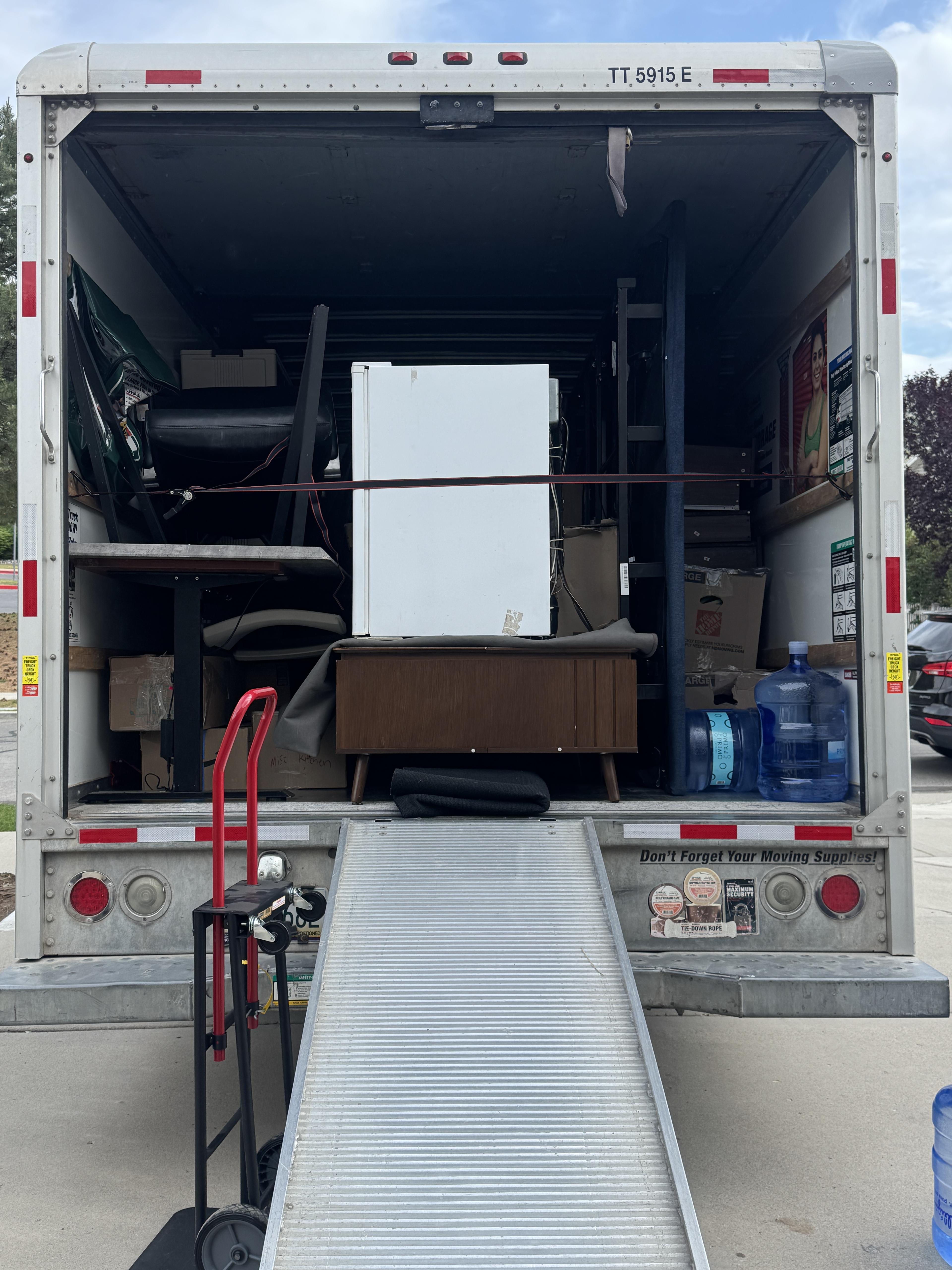 Ready Relocation trailer with ramp and furniture loaded for a move